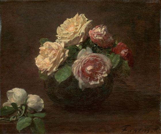 Still life of cream, pink and red roses in a dark bowl, with two white roses lying on the table beside it.